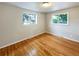 Spacious bedroom with hardwood floors and two windows at 123 Emerald St, Broomfield, CO 80020