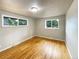 Light and airy bedroom with two windows and hardwood floors at 123 Emerald St, Broomfield, CO 80020