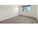 Bright bedroom with grey carpet and a window offering an outdoor view at 725 S Clinton St # 7B, Denver, CO 80247