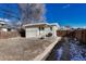 Backyard with a detached garage, wooden fence, and a gravel area at 2031 Meade St, Denver, CO 80211