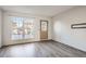 Living room with large windows and laminate floors at 9640 W Cornell Pl, Lakewood, CO 80227