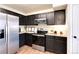 Well-equipped kitchen with stainless steel appliances and dark cabinets at 18397 E Alabama Pl # D, Aurora, CO 80017