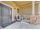 Covered front porch with stonework and comfortable seating area at 958 Eldorado Ln, Louisville, CO 80027