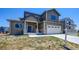 Two-story home with gray siding, stone accents, and a two-car garage at 958 Eldorado Ln, Louisville, CO 80027