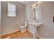 Small bathroom with pedestal sink, toilet and light wood floors at 958 Eldorado Ln, Louisville, CO 80027