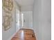 Foyer with hardwood floors, white door, and geometric wall art at 958 Eldorado Ln, Louisville, CO 80027