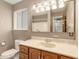 Bathroom with wood vanity and updated lighting fixtures at 406 Titan Ct, Aurora, CO 80011