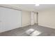 Bright basement bedroom with double doors and plush carpeting at 5144 Billings St, Denver, CO 80239