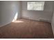 Bright bedroom with neutral carpeting and a window with blinds at 14794 E 2Nd Ave # 111F, Aurora, CO 80011