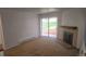Bright living room featuring a fireplace and access to a private patio at 14794 E 2Nd Ave # 111F, Aurora, CO 80011