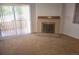 Living room with fireplace and sliding glass door leading to a patio at 14794 E 2Nd Ave # 111F, Aurora, CO 80011
