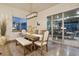 Bright dining room with a rustic wooden table and access to a deck at 3554 Forest Lakes Dr, Monument, CO 80132