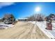 House with a long driveway and snow-covered front yard at 13820 E 133Rd Dr, Brighton, CO 80601