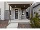 Covered front porch with stone facade and a modern door at 23630 E 5Th Pl, Aurora, CO 80018