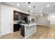 Well-equipped kitchen with dark cabinets and granite countertops at 23630 E 5Th Pl, Aurora, CO 80018