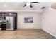 Living room with wood-look floors, ceiling fan, and access to patio at 23630 E 5Th Pl, Aurora, CO 80018