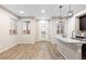 Open living room with wood-look floors and access to kitchen at 23630 E 5Th Pl, Aurora, CO 80018