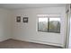 Spacious bedroom with neutral walls, wall-to-wall carpet, and large window at 13890 E Marina Dr # 612, Aurora, CO 80014
