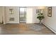 Bright living room with wood-look floors, sliding door to balcony, and ample natural light at 13890 E Marina Dr # 612, Aurora, CO 80014