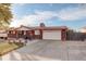 Brick ranch home with attached garage and landscaping at 6336 W 71St Pl, Arvada, CO 80003