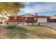 Brick ranch house with a two-car garage and landscaping at 6336 W 71St Pl, Arvada, CO 80003