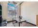 Modern office space with large window, glass desk, and comfortable chairs at 1499 Blake St # 1A & 1B, Denver, CO 80202