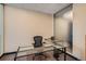 Private office featuring a glass desk, ergonomic chair, and frosted glass partition at 1499 Blake St # 1A & 1B, Denver, CO 80202