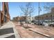 Paved street with trees and parked cars, showcasing urban neighborhood at 1499 Blake St # 1A & 1B, Denver, CO 80202