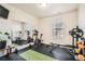 Home gym with exercise bikes, weights, and a large mirror at 12773 N Leyden St # A, Thornton, CO 80602