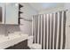 Clean bathroom with updated vanity and shower with striped curtain at 425 Crystal Pl, Longmont, CO 80504