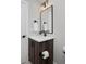 Bathroom vanity with dark wood cabinets, white countertop, and black fixtures at 3916 N Raleigh St, Denver, CO 80212