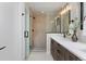 Modern bathroom with a walk-in shower, double vanity, and contemporary fixtures at 3916 N Raleigh St, Denver, CO 80212