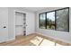 Bedroom with hardwood floors, white closet, and large window at 3916 N Raleigh St, Denver, CO 80212