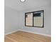 Empty bedroom with large window and hardwood floors at 3916 N Raleigh St, Denver, CO 80212