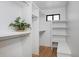Spacious walk-in closet with built-in shelving and a bench at 3916 N Raleigh St, Denver, CO 80212