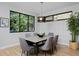 Dining room with a modern light fixture, large window, and hardwood floors at 3916 N Raleigh St, Denver, CO 80212