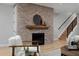 Brick fireplace with a wooden mantel and a staircase in the background at 3916 N Raleigh St, Denver, CO 80212