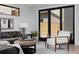Living area with sliding glass doors leading to a fenced backyard at 3916 N Raleigh St, Denver, CO 80212