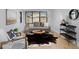 Living room with modern furniture, a cowhide rug, and large windows at 3916 N Raleigh St, Denver, CO 80212
