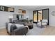 Living room with comfortable seating, a large rug, and access to the backyard at 3916 N Raleigh St, Denver, CO 80212