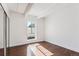 Simple bedroom with hardwood floors and large window at 8060 E Girard Ave # 419, Denver, CO 80231