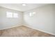 Spacious bedroom with neutral carpet and two windows at 640 Sable Blvd, Aurora, CO 80011