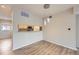 Dining area with wood-look flooring, a stylish light fixture, and a pass-through window to the kitchen at 2971 W 119Th Ave # 204, Westminster, CO 80234