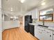 Kitchen with white cabinets, granite counters, and a farmhouse sink at 7059 S Tamarac Ct, Centennial, CO 80112