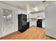 Galley kitchen with white cabinets and black appliances at 7059 S Tamarac Ct, Centennial, CO 80112