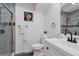 Modern bathroom with white vanity, gray marble shower, and hexagon tile at 2366 S Devinney St, Lakewood, CO 80228