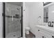 Clean bathroom with a white vanity, gray marble shower, and hexagon tile at 2366 S Devinney St, Lakewood, CO 80228