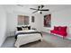 Spacious bedroom with queen bed, ceiling fan and pink accent chair at 2366 S Devinney St, Lakewood, CO 80228