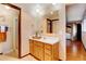 Clean bathroom featuring oak vanity, large mirror, and shower at 10090 E Ohio Ave, Denver, CO 80247