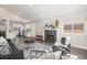 Open concept living room with a fireplace and view into the kitchen at 13359 W 71St Pl, Arvada, CO 80004